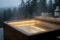 A bird's-eye view of a Scandinavian spa made of solid wood (Atelier Nordic), gently steaming in the twilight of early evening.